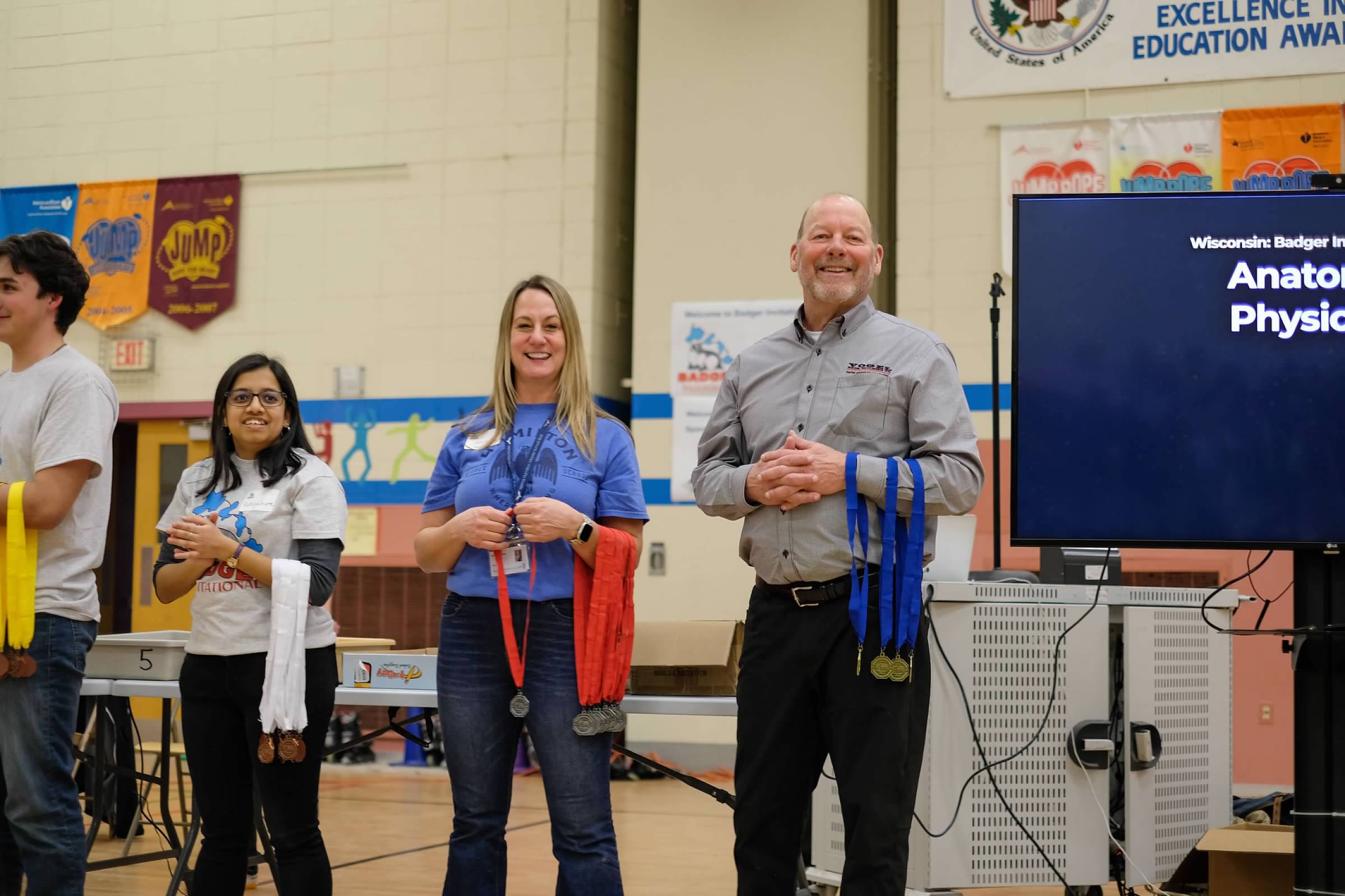 3 people handing out medals