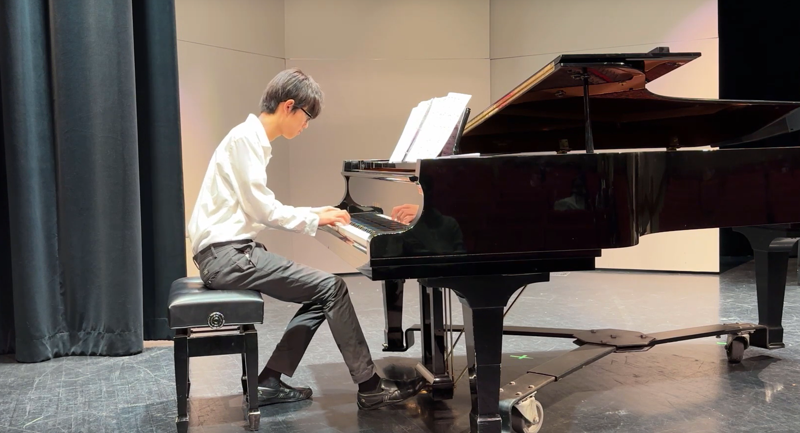 asian male playing piano